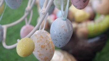 easter concept with multi color egg hanging on a decorative tree video