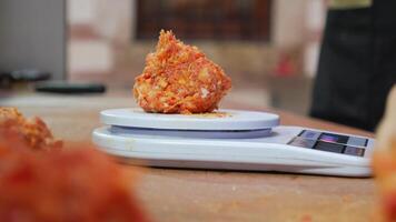 Accurately measure ground meat with a digital kitchen scale for precise cooking results video