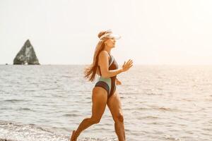 Woman travel summer sea. A happy tourist in a blue bikini enjoying the scenic view of the sea and volcanic mountains while taking pictures to capture the memories of her travel adventure. photo