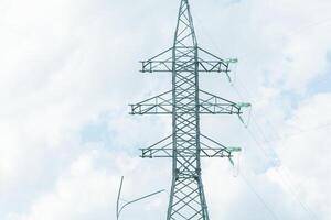 High voltage towers with sky background. Power line support with wires for electricity transmission. High voltage grid tower with wire cable at distribution station. Energy industry, energy saving photo
