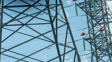 High voltage towers with sky background. Power line support with wires for electricity transmission. High voltage grid tower with wire cable at distribution station. Energy industry, energy saving photo