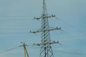 High voltage towers with sky background. Power line support with wires for electricity transmission. High voltage grid tower with wire cable at distribution station. Energy industry, energy saving photo