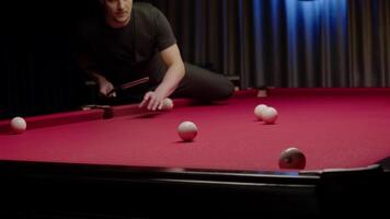 Despite the best efforts of the billiards player, the ball misses the pocket and bounces away from the table. Mid shot. Slow motion video