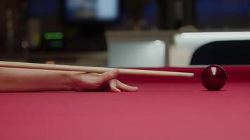 close-up of hitting a billiard ball with a cue in profile. Close up. Slow motion video
