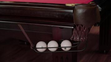 Side view of the pocket into which the billiard ball rolls after being hit. Close up. Slow motion video