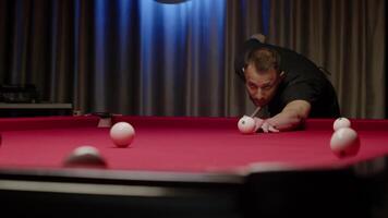 Player almost hits the target with the billiard ball, but at the last second it bounces off the side. The man feels disappointed. Mid shot. Slow motion video