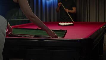 Professional billiards player takes out a cue from a case before a game. She prepares for the match by collecting her equipment. Mid shot. Slow motion video