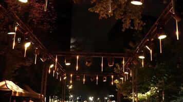 Lighting fixtures shimmer with a variety of colors in the open air video