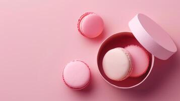 Mini macaroon on paper box gift package copy space isolated pink background photo
