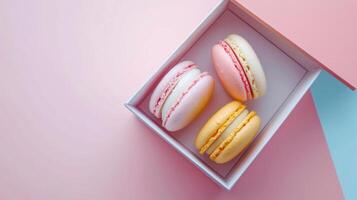 Mini macaroon on paper box gift package copy space isolated pink background photo