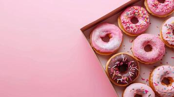 Sweet donuts rounded bread on paper box with topping cream and springkles copy space photo