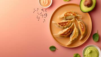 Flat lay gyoza with sauce, avocado slice and leaf copy space isolated photo