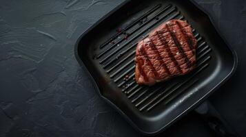 Flat lay beef steak on black grill pan barbecue copy space black background photo