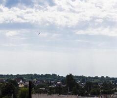 Silhouette of the MIG fighter jet in the cloudy sky. Military photo