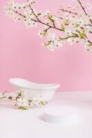 Empty podium or pedestal with spring bloom and bath. Spring mock up for cosmetic products photo