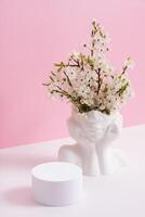 Empty podium or pedestal with spring bloom. Spring mock up for cosmetic products photo