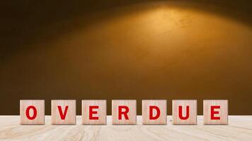 Overdue, Wooden on the office desk, informative and communication background, Word OVERDUE made with wood building blocks, OVERDUE word on block concept. photo