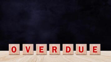 Overdue, Wooden on the office desk, informative and communication background, Word OVERDUE made with wood building blocks, OVERDUE word on block concept. photo