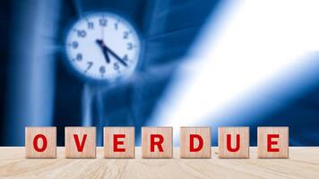 Overdue, Wooden on the office desk, informative and communication background, Word OVERDUE made with wood building blocks, OVERDUE word on block concept. photo