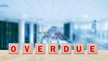 Overdue, Wooden on the office desk, informative and communication background, Word OVERDUE made with wood building blocks, OVERDUE word on block concept. photo