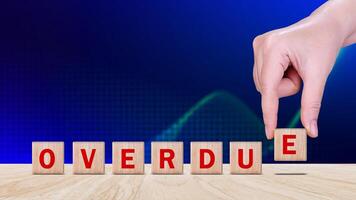 Overdue, Wooden on the office desk, informative and communication background, Word OVERDUE made with wood building blocks, OVERDUE word on block concept. photo