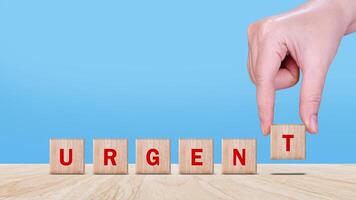 URGENT, Wooden blocks with URGENT text and Business concept, informative and communication background, Urgent Notice Important Quick Serious Speed Concept. photo