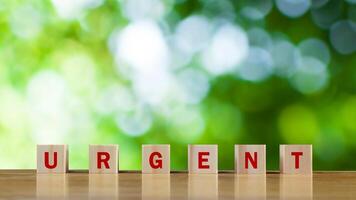 URGENT, Wooden blocks with URGENT text and Business concept, informative and communication background, Urgent Notice Important Quick Serious Speed Concept. photo