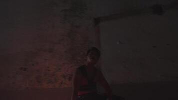 Blurred person illuminated by warm light in dark setting video