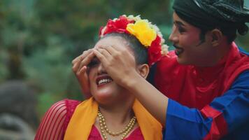 Couple in traditional attire enjoying a festive event video