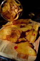 Keripik Singkong pedas or spicy Cassava Chips, Indonesian traditional snack. Made of cassava sliced, fried and cooked with chilli. photo