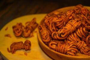 Mie gulung kering is a snack made from wheat flour and tapioca sprinkled with powdered spices. There are spicy, cheesy and original flavors. photo