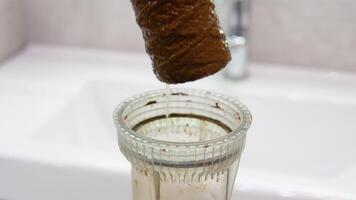 Plumber working replaceable dirty used water filter. Dirty rusty filter for water purification video