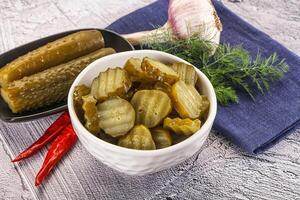 Sliced marinated cucumbers in the bowl photo
