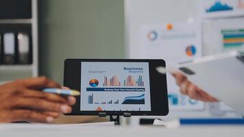 Business meeting time,business account managers crew working with new startup project,report analysis cost graph on desk at meeting room. video