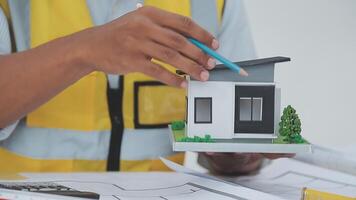 architect man working with laptop and blueprints,engineer inspection in workplace for architectural plan,sketching a construction project ,selective focus,Business concept vintage color video