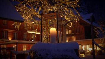 Cozy Winter Evening with Candle Lantern and Festive Lights creating a warm and inviting ambiance video