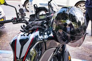 Raanana, Israel. May 19, 2023. Black gloves and Bell black motorcycle helmet. photo