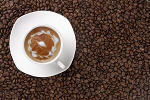 Close up of roasted coffee beans with foam top view photo