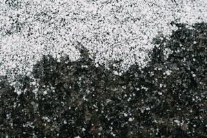 Selective focus. First snow on a frozen field plants, late autumn close-up. Beautiful abstract frozen microcosmos pattern. Freezing weather frost action in nature. Floral backdrop. photo