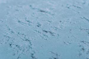 Selective focus. First frost on a frozen car, late autumn close-up. Beautiful abstract frozen microcosmos pattern. Freezing weather frost action in nature. Winter backdrop. photo