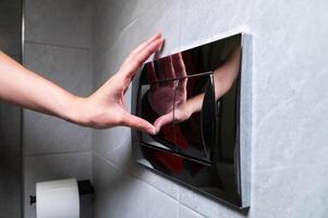 Economic toilet flush press with two separate buttons. Flushing water using dual machanism of concealed toilet cistern. Modern bathroom elements photo