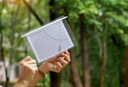 A simple clinometer made from paper is a device for easily measuring the height of objects such as trees, buildings, or tall buildings using the principles of trigonometry and Pythagoras' theory. photo