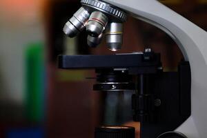 Compound Microscope focuses on the objective lens. It is a biology laboratory equipment used to magnify small objects into larger images. photo