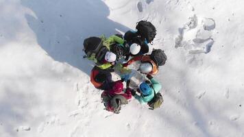 the climbers made camp on a hill and stood in a circle near the map, in order to choose the further direction of the route, in the campaign. video