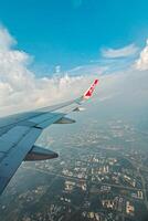 Footage of a clear, white cloudy sky from a commercial airplane window. The view from inside the plane is a daytime sky with white clouds moving smoothly photo