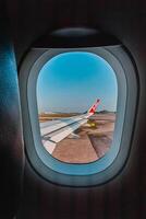 Footage of a clear, white cloudy sky from a commercial airplane window. The view from inside the plane is a daytime sky with white clouds moving smoothly photo