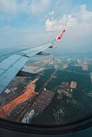 Footage of a clear, white cloudy sky from a commercial airplane window. The view from inside the plane is a daytime sky with white clouds moving smoothly photo