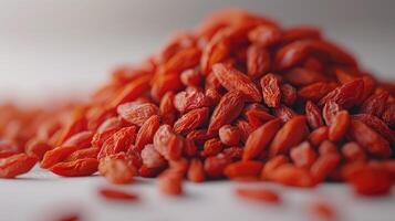 Goji berries emphasizing the vibrant red color and texture of the berries. photo