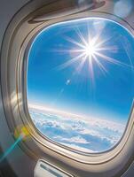 Sunlit airplane window view of sky and clouds scene. photo