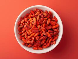 Bowl of dried goji berries emphasizing the vibrant red color and texture of the berries. photo
